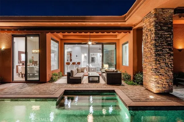 a backyard of a house with a yard and outdoor seating