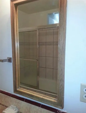 a bathroom with a glass shower door