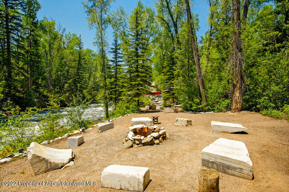73 Juniper Court Marble, CO 81623 - Photo 12 of 47 a view of a backyard with table and chairs couches under an umbrella