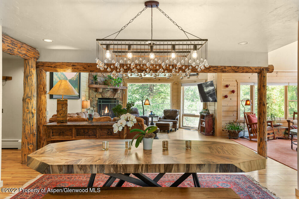 73 Juniper Court Marble, CO 81623 - Photo 19 of 47 a view of a dining room with furniture a chandelier and wooden floor