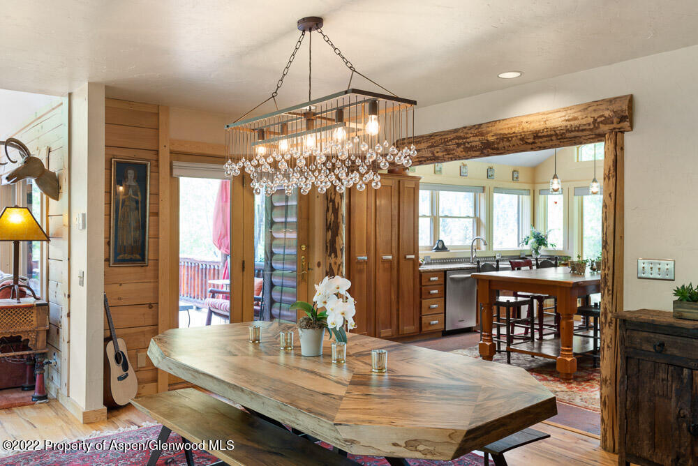 73 Juniper Court Marble, CO 81623 - Photo 20 of 47 a dining room with chandelier and wooden floor