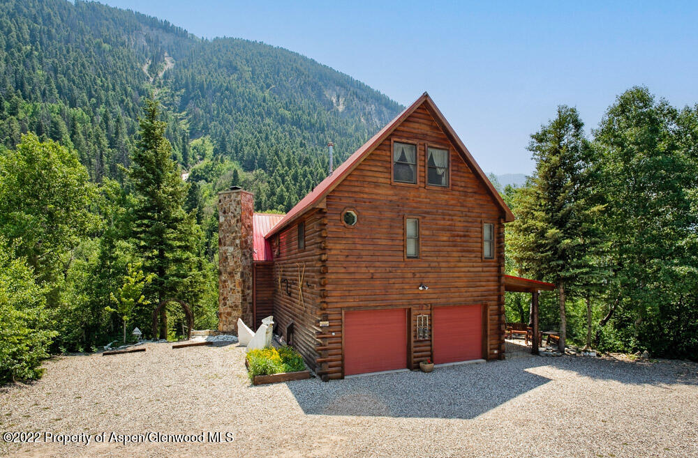 73 Juniper Court Marble, CO 81623 - Photo 2 of 47 a view of a house with a small yard and a large tree