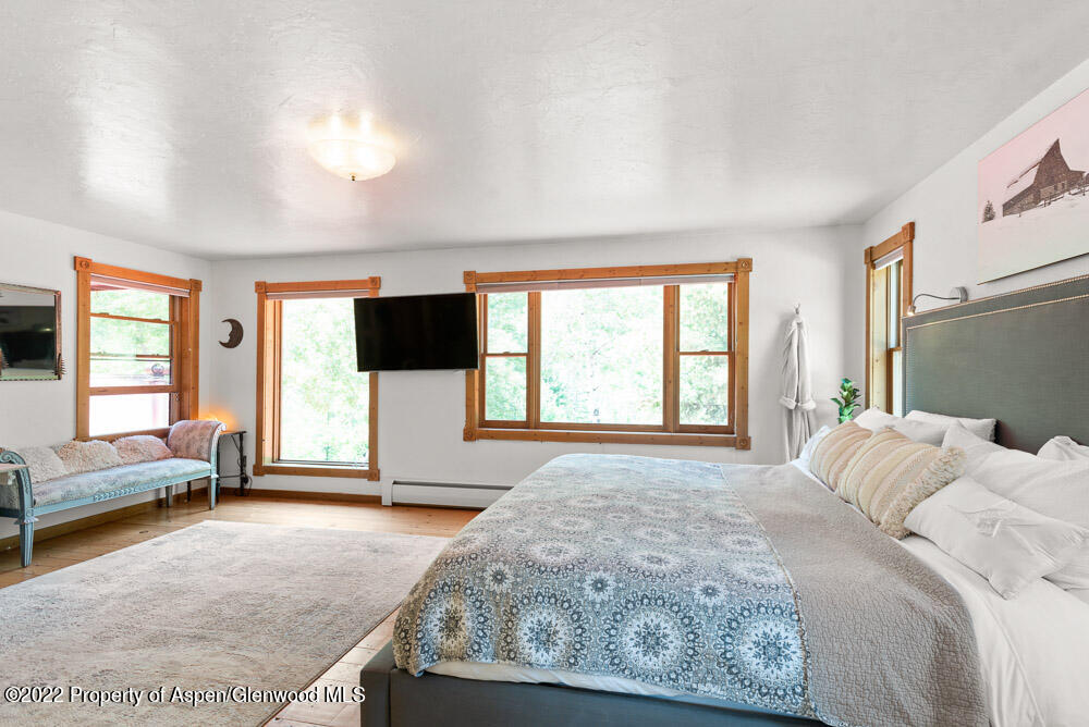 73 Juniper Court Marble, CO 81623 - Photo 23 of 47 a spacious bedroom with a bed a window and television