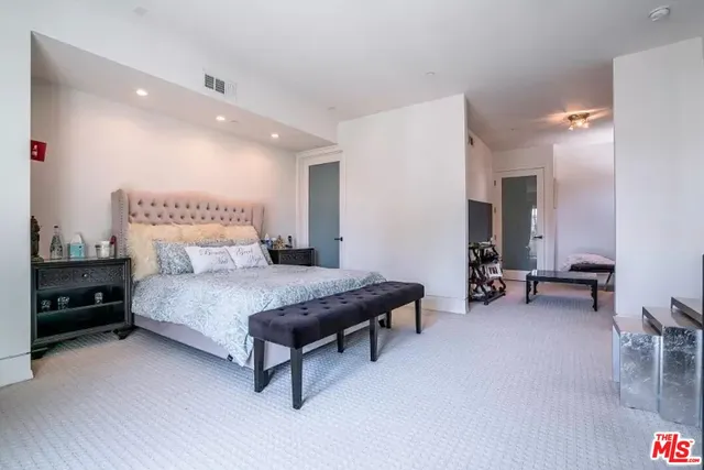 a bedroom with furniture and a mirror