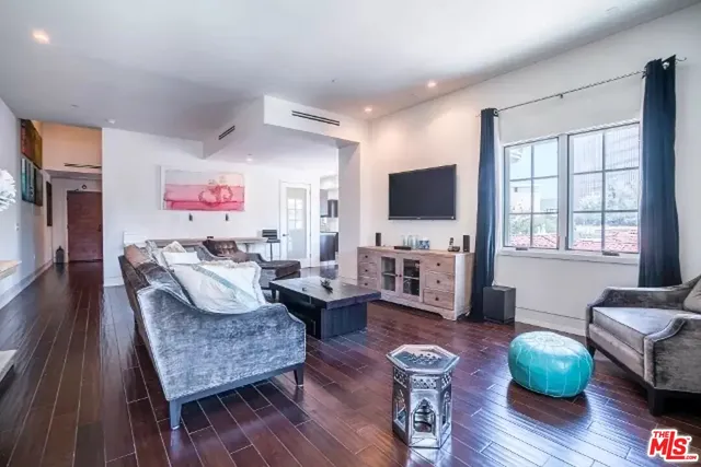 a living room with fireplace furniture and a flat screen tv