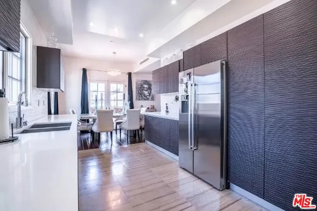 a kitchen with stainless steel appliances granite countertop a refrigerator stove microwave and cabinets