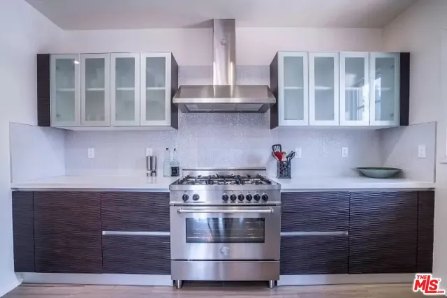a kitchen with granite countertop a stove and a cabinets