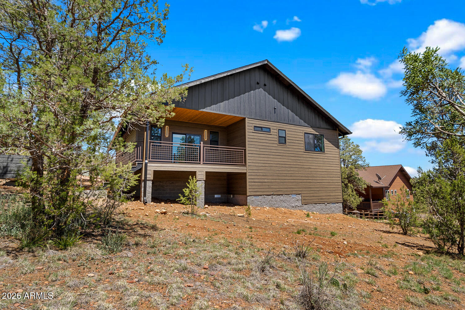2235 Par Place Overgaard, AZ 85933 - Photo 11 of 42 a front view of a house with a yard and garage