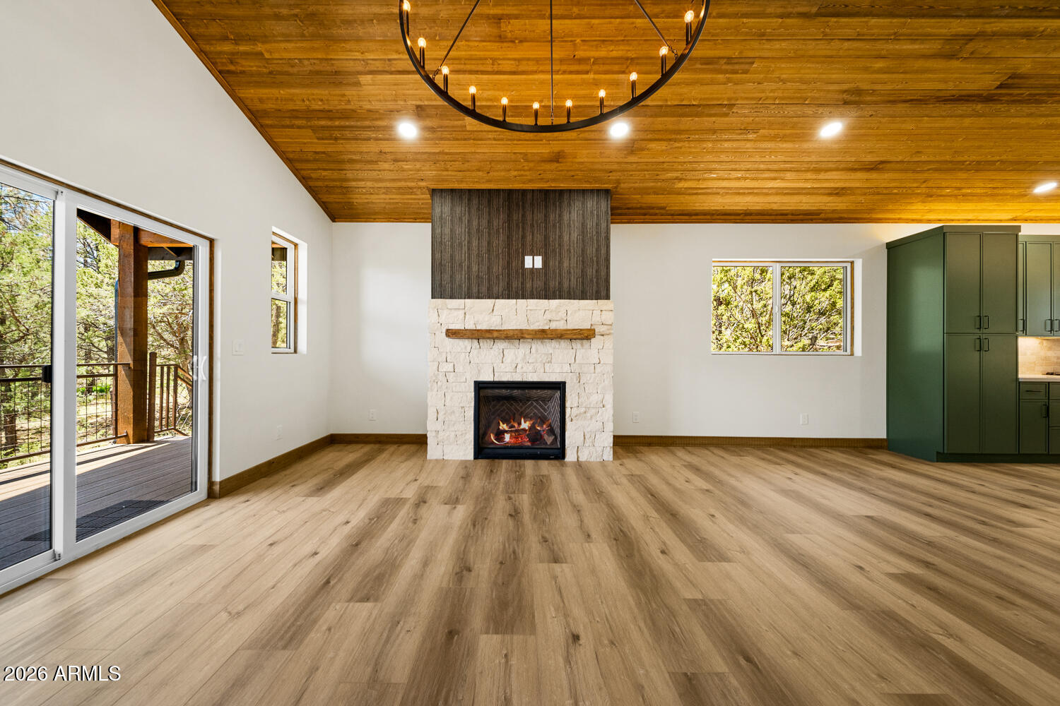 2235 Par Place Overgaard, AZ 85933 - Photo 20 of 42 a view of an empty room with a fireplace and a window