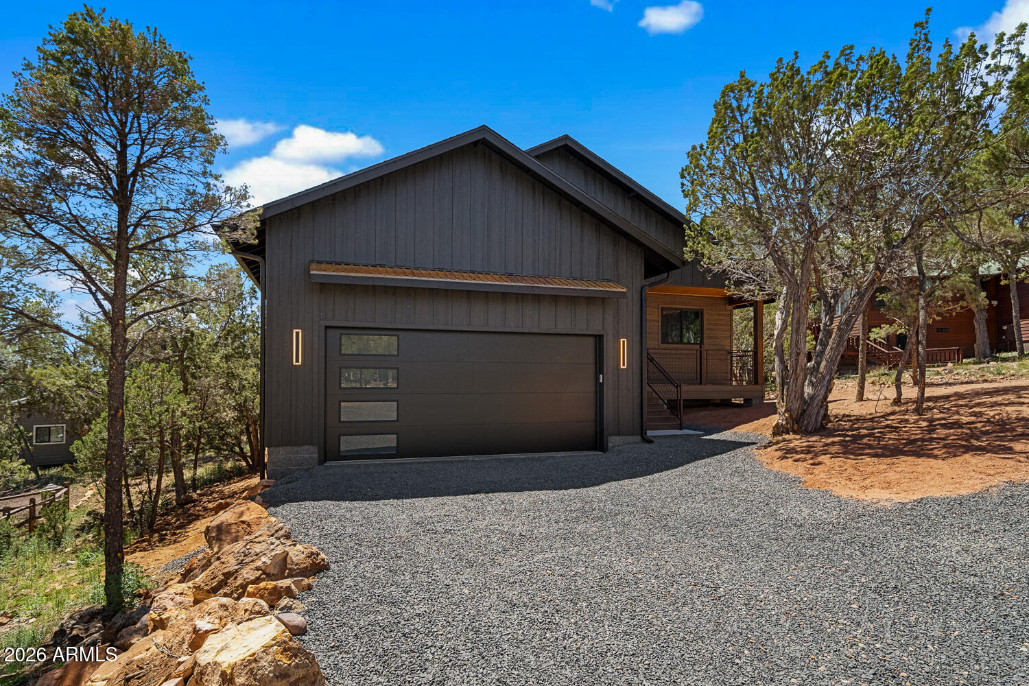 2235 Par Place Overgaard, AZ 85933 - Photo 2 of 42 a front view of a house with a yard and garage