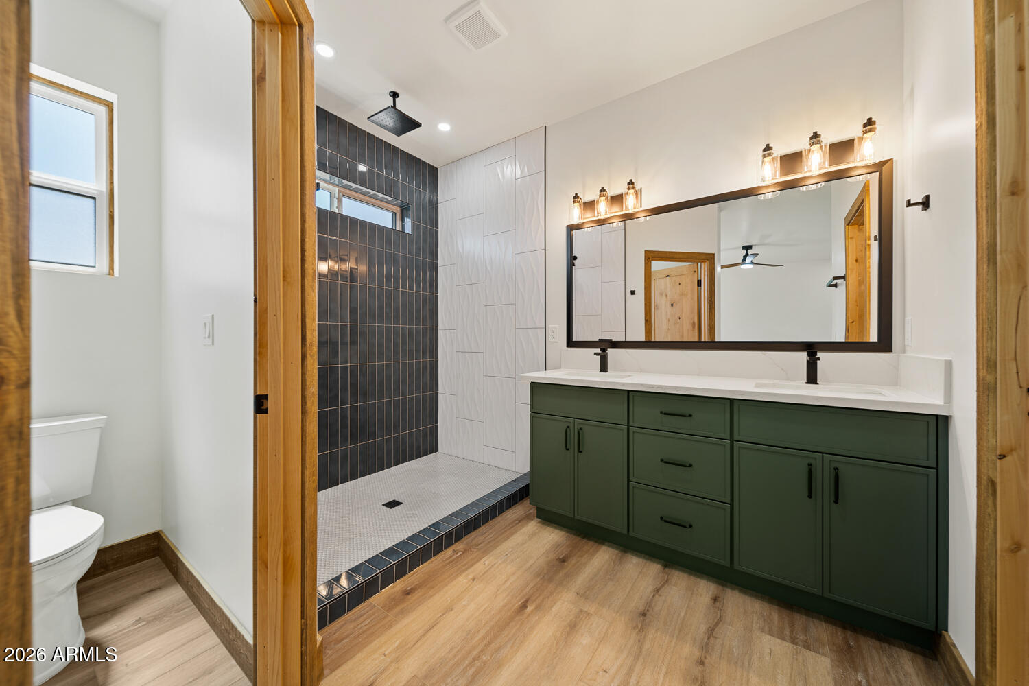 2235 Par Place Overgaard, AZ 85933 - Photo 32 of 42 a bathroom with a double vanity sink mirror and shower