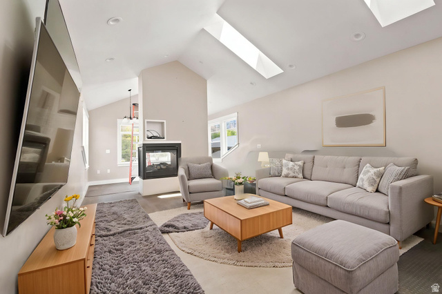 580 North 300 East Logan, UT 84321 - Photo 48 of 74 Living area featuring vaulted ceilings, recessed lighting, and multiple skylights