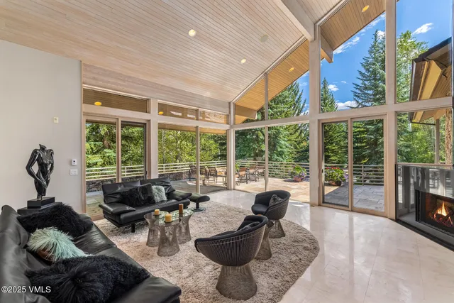 a living room with furniture and a floor to ceiling window