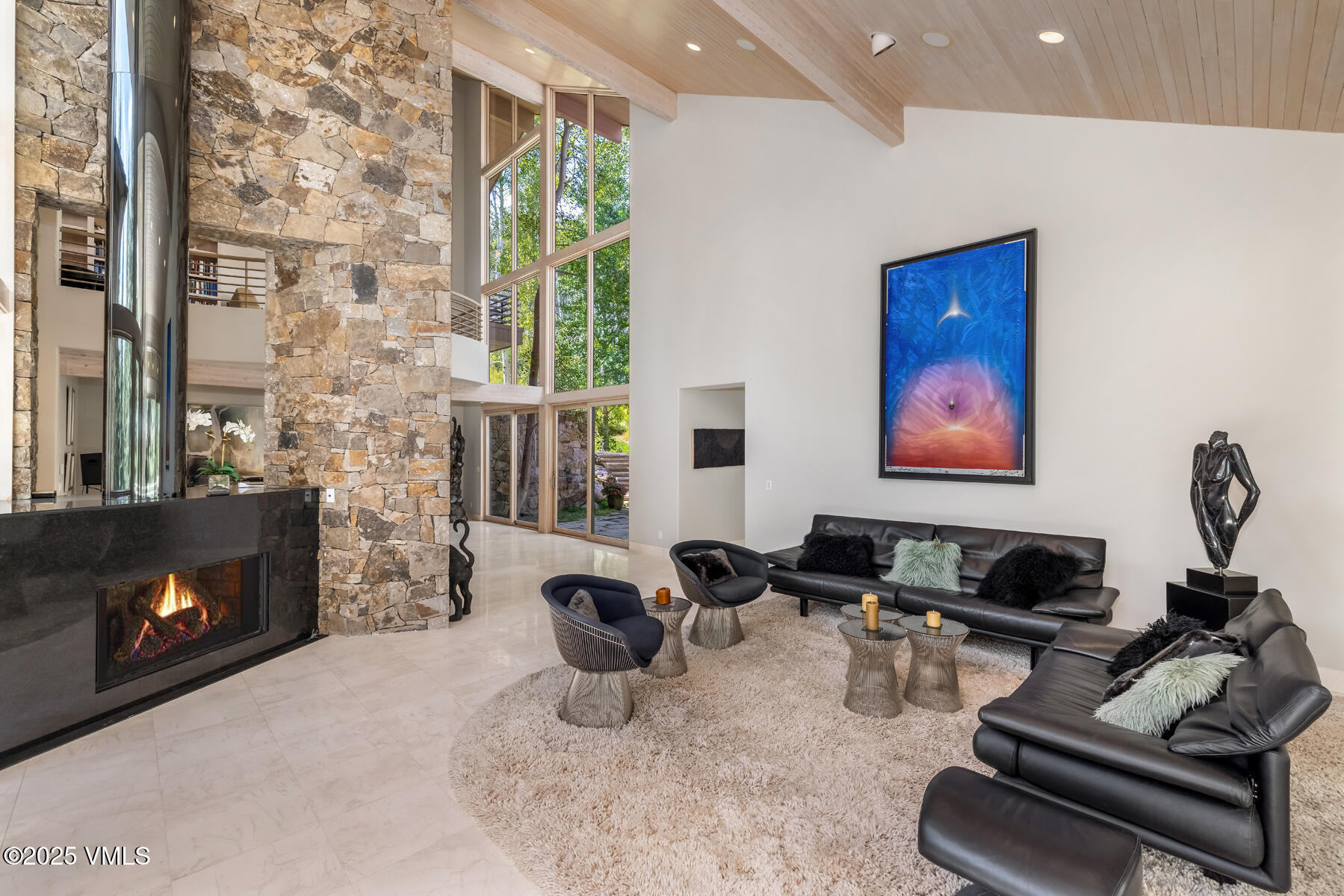 334 Borders Road Beaver Creek, CO 81620 - Photo 14 of 62 a living room with furniture a fireplace and a floor to ceiling window