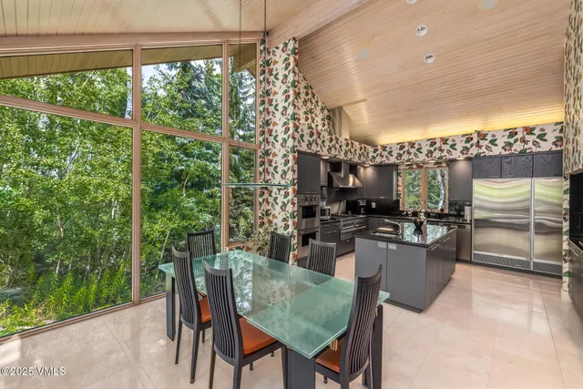 a dining room with furniture a window and kitchen view