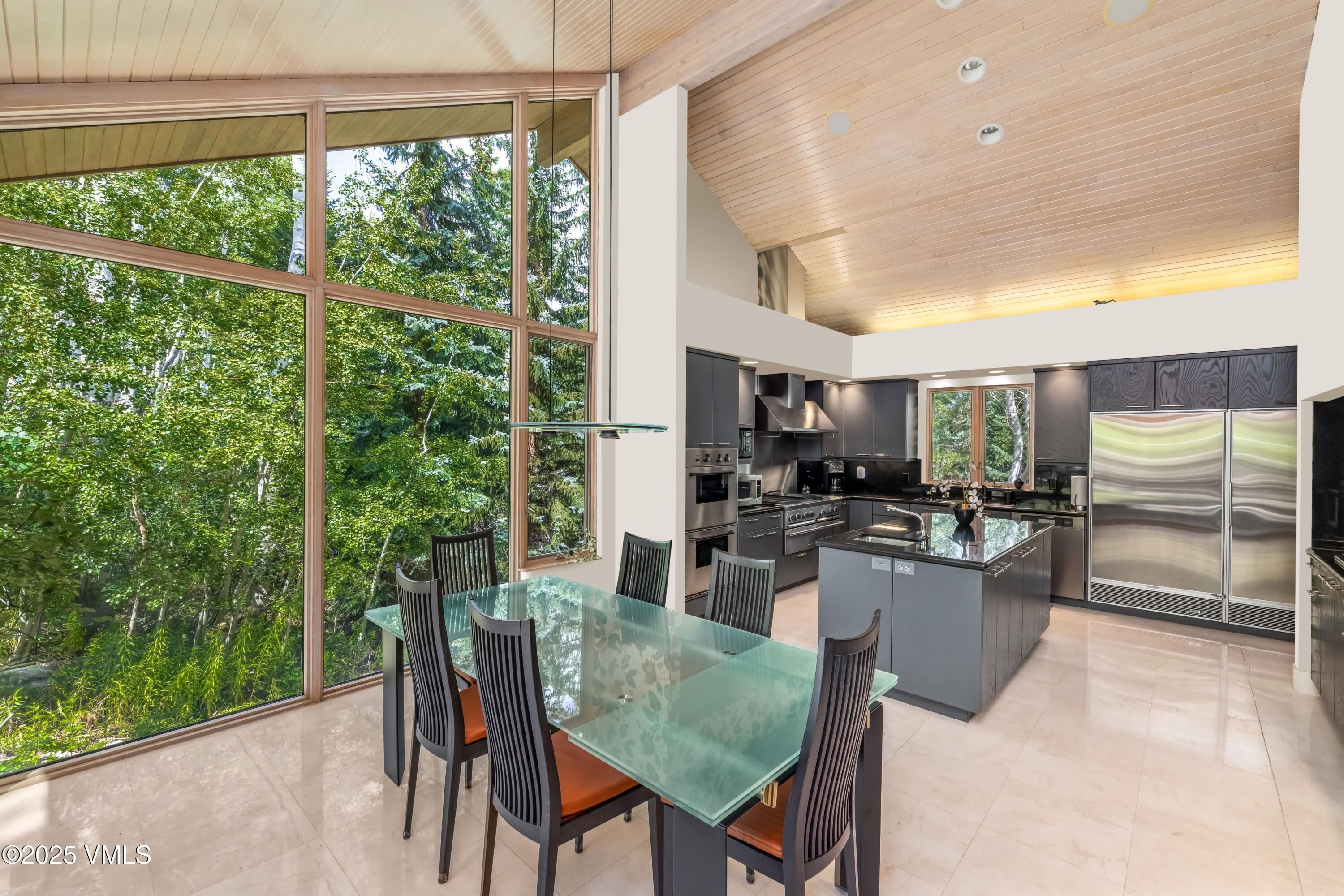 334 Borders Road Beaver Creek, CO 81620 - Photo 16 of 62 a dining room with furniture a window and kitchen view