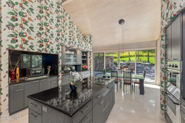 a dining room with furniture and garden view