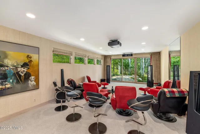 a bedroom with furniture and a large window