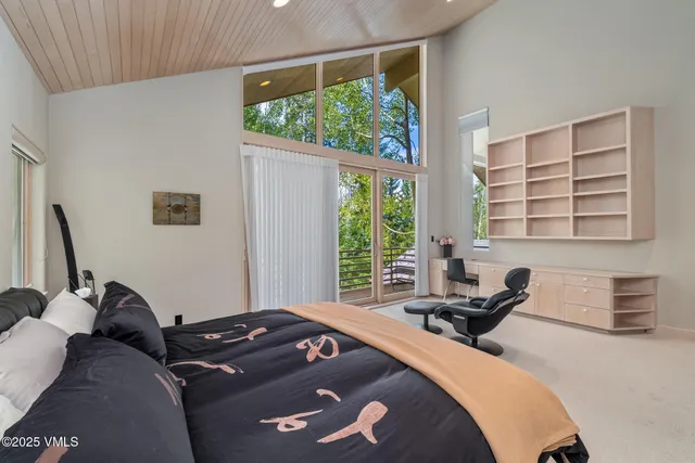 a bedroom with a bed and large window