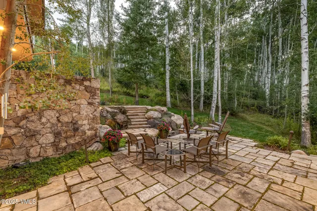 a view of a patio with a table and chairs