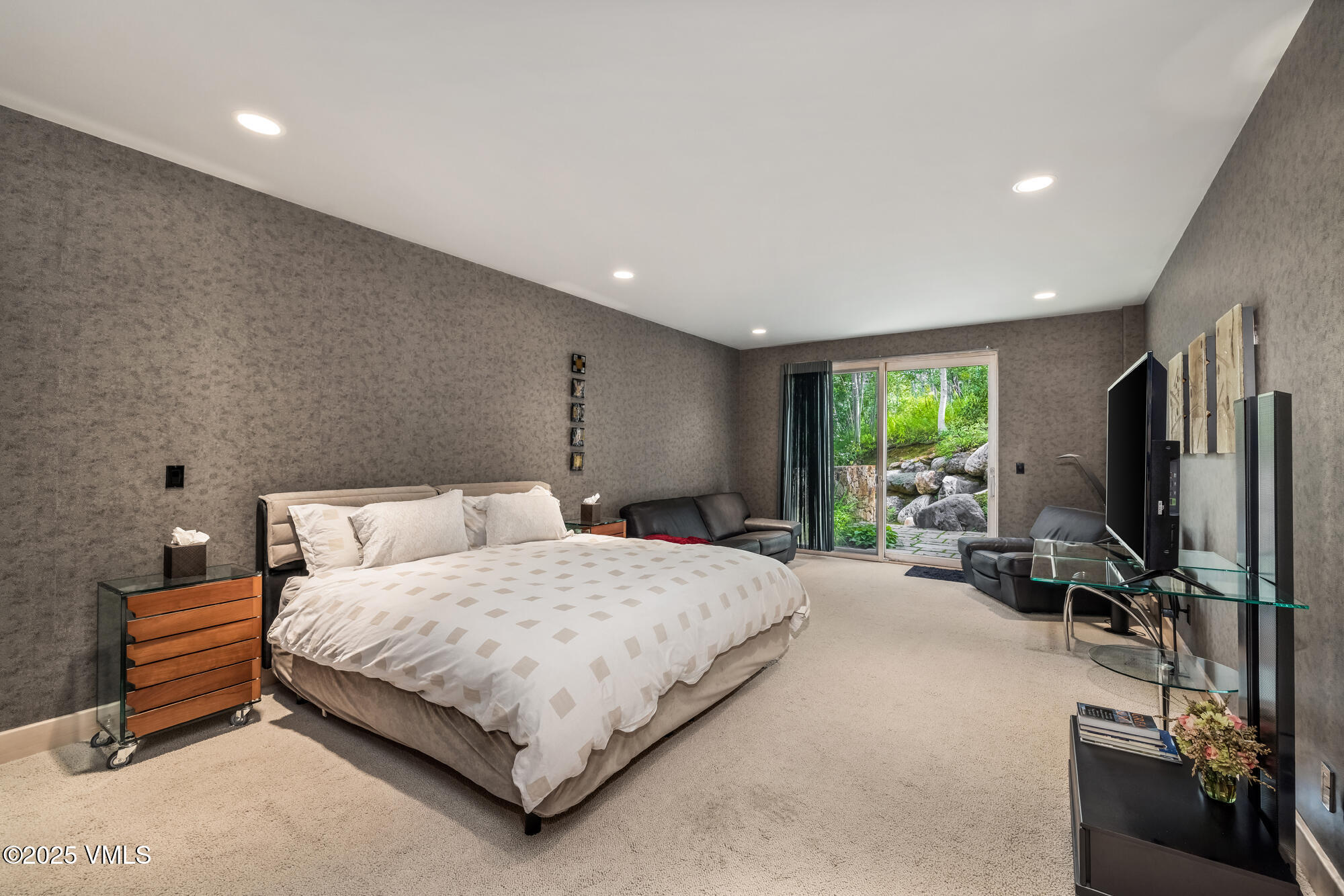 334 Borders Road Beaver Creek, CO 81620 - Photo 42 of 62 a bedroom with a bed a couch and a flat screen tv