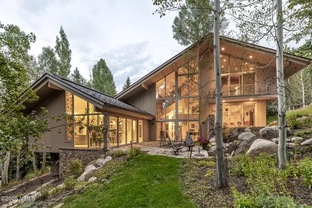 a view of backyard of house with outdoor seating and green space