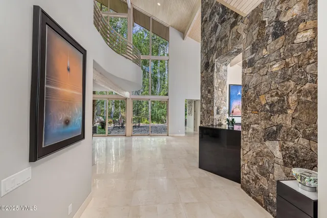 a view of a big room with wooden floor and windows