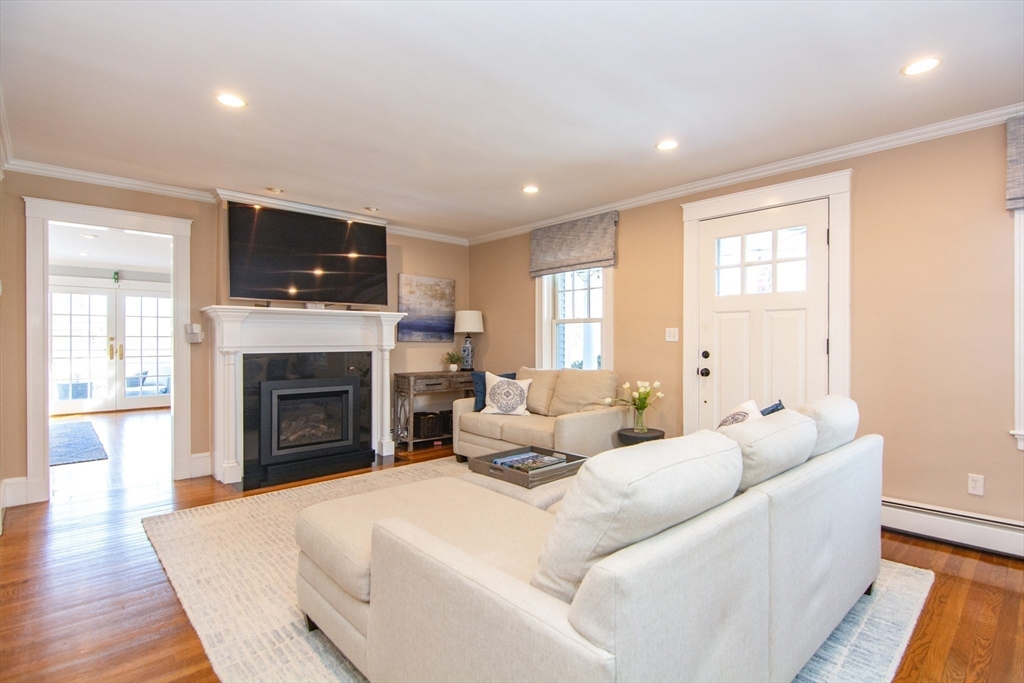 1289 Walnut Street Newton, MA 02461 - Photo 11 of 42 a living room with furniture a fireplace and a flat screen tv