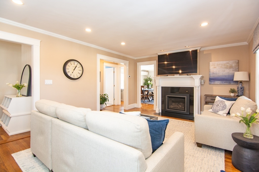 1289 Walnut Street Newton, MA 02461 - Photo 12 of 42 a living room with furniture a fireplace and a flat screen tv