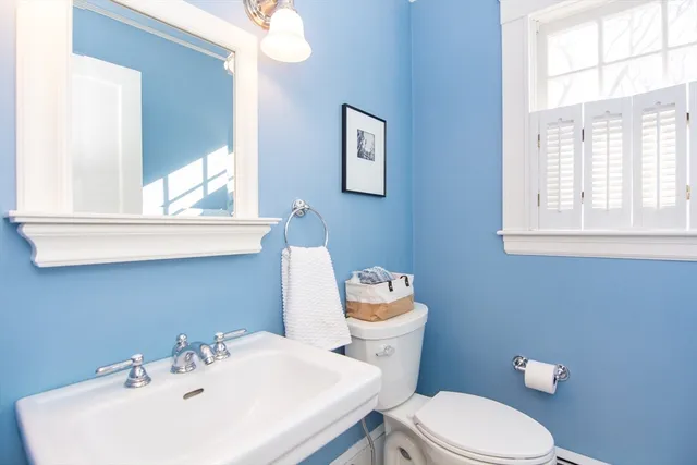 a white toilet sitting next to a bathroom sink