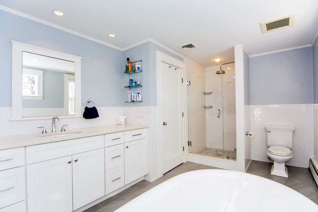 1289 Walnut Street Newton, MA 02461 - Photo 21 of 42 a spacious bathroom with a double vanity sink toilet and shower