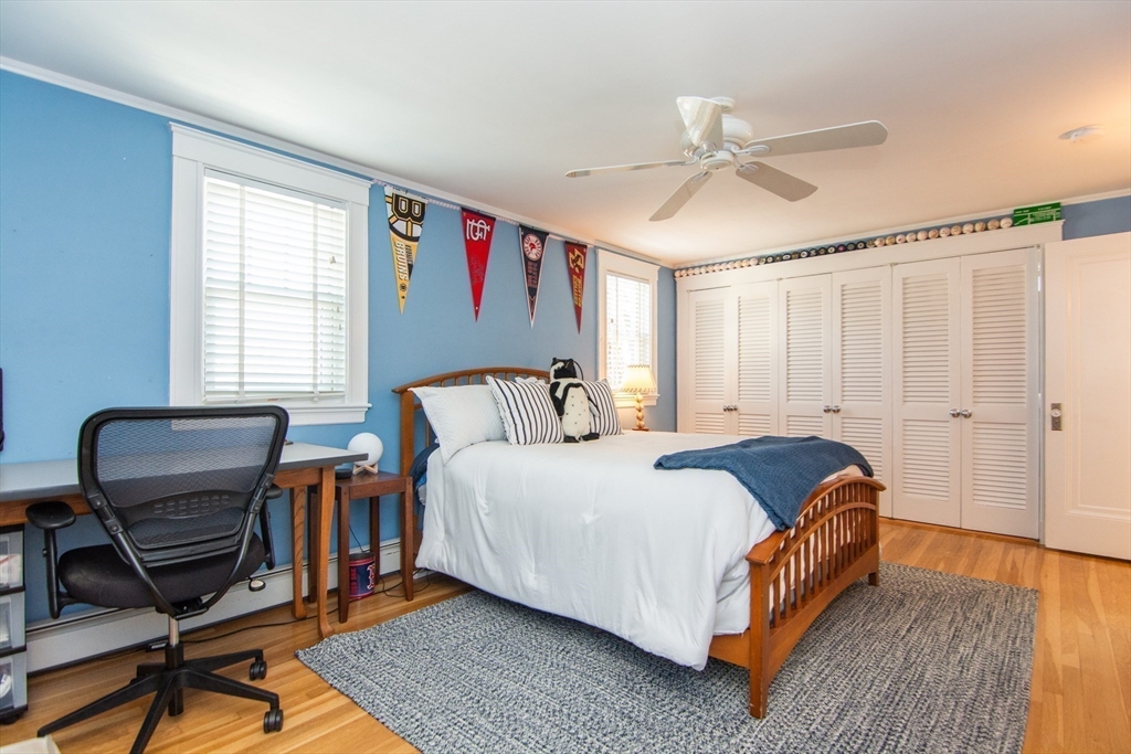 1289 Walnut Street Newton, MA 02461 - Photo 23 of 42 a bed room with a bed and a chair