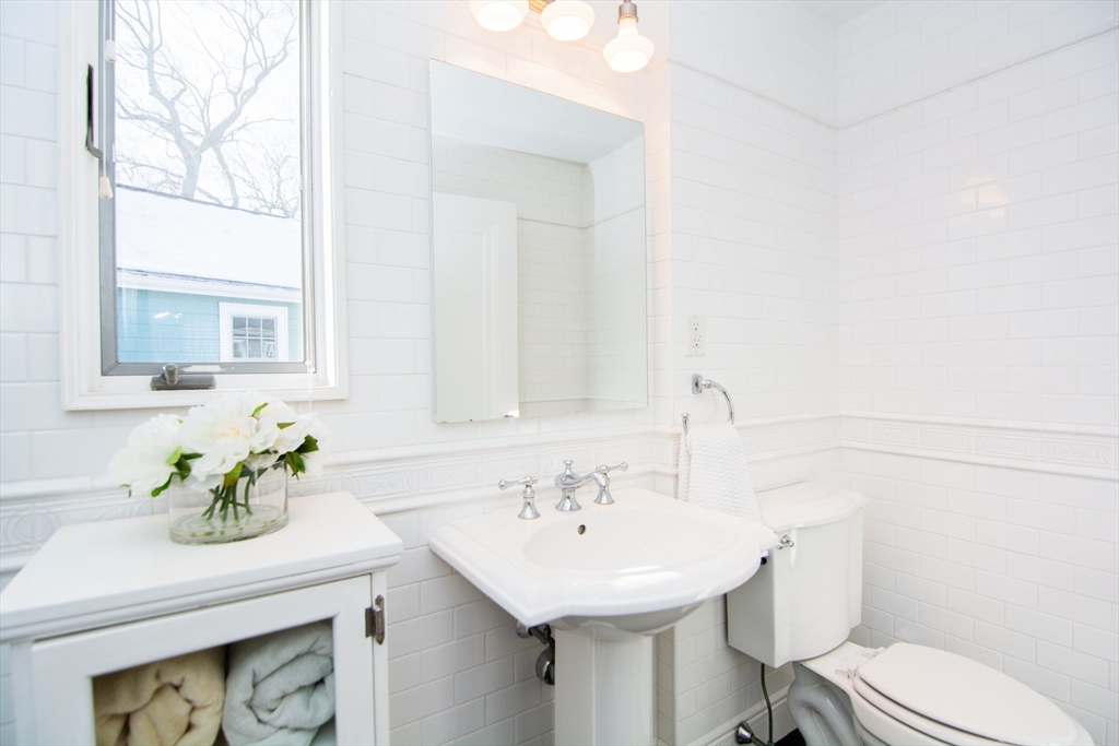 1289 Walnut Street Newton, MA 02461 - Photo 28 of 42 a bathroom with a sink toilet and a mirror