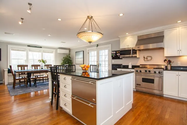 a kitchen with stainless steel appliances granite countertop a stove and a refrigerator