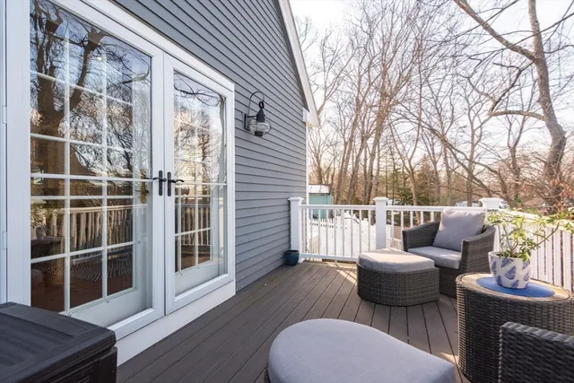 a view of a patio with couches chairs and wooden floor
