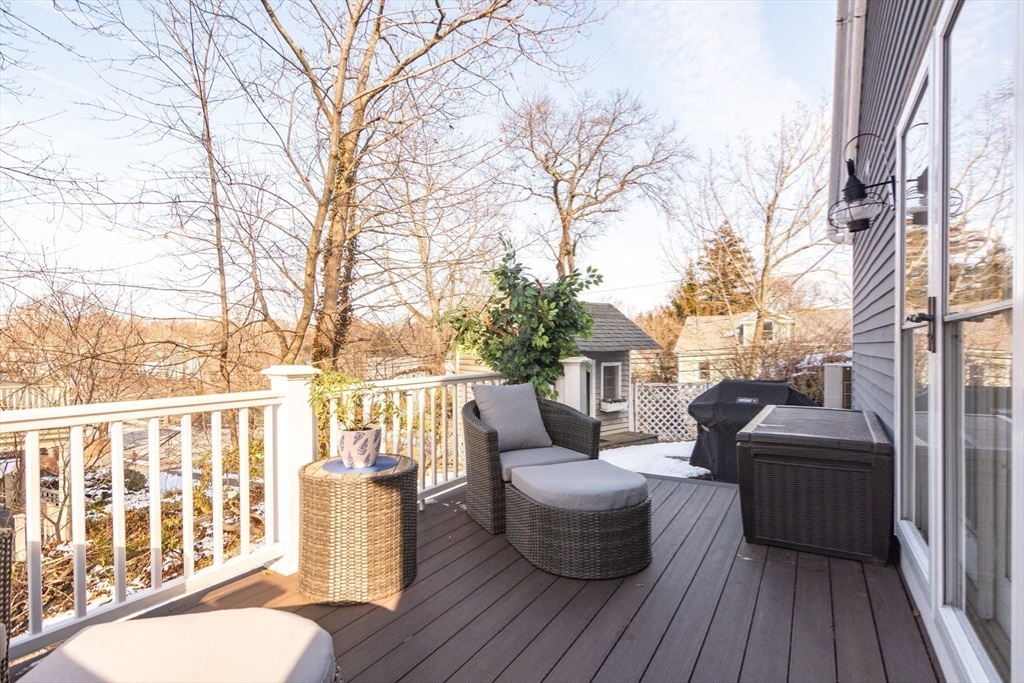 1289 Walnut Street Newton, MA 02461 - Photo 32 of 42 a balcony with wooden floor table and chairs