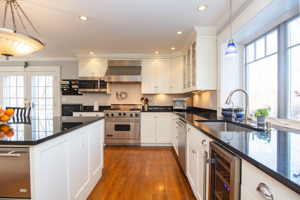 1289 Walnut Street Newton, MA 02461 - Photo 5 of 42 a kitchen with granite countertop a sink a counter top space stainless steel appliances and cabinets