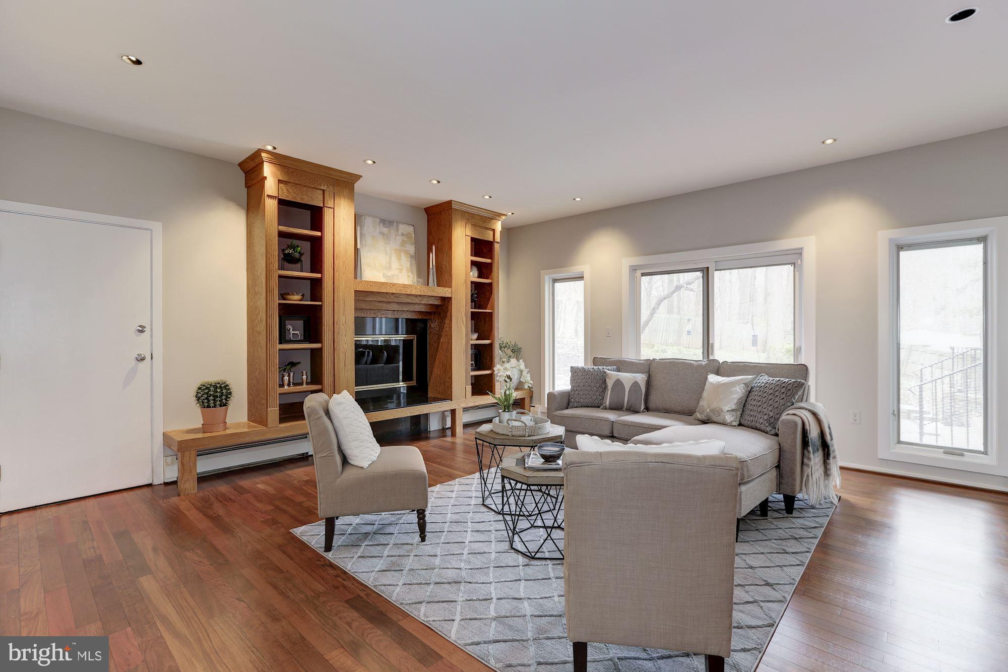 8707 Burning Tree Road Bethesda, MD 20817 - Photo 22 of 69 Den with built-ins surrounding the wood fireplace