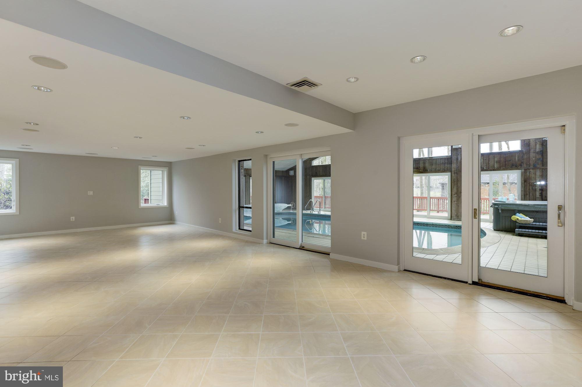 8707 Burning Tree Road Bethesda, MD 20817 - Photo 53 of 69 Lower level recreation room leading to the pool