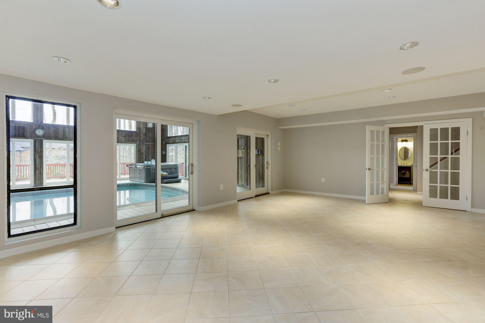 8707 Burning Tree Road Bethesda, MD 20817 - Photo 54 of 69 Recreation room with sliders to the pool