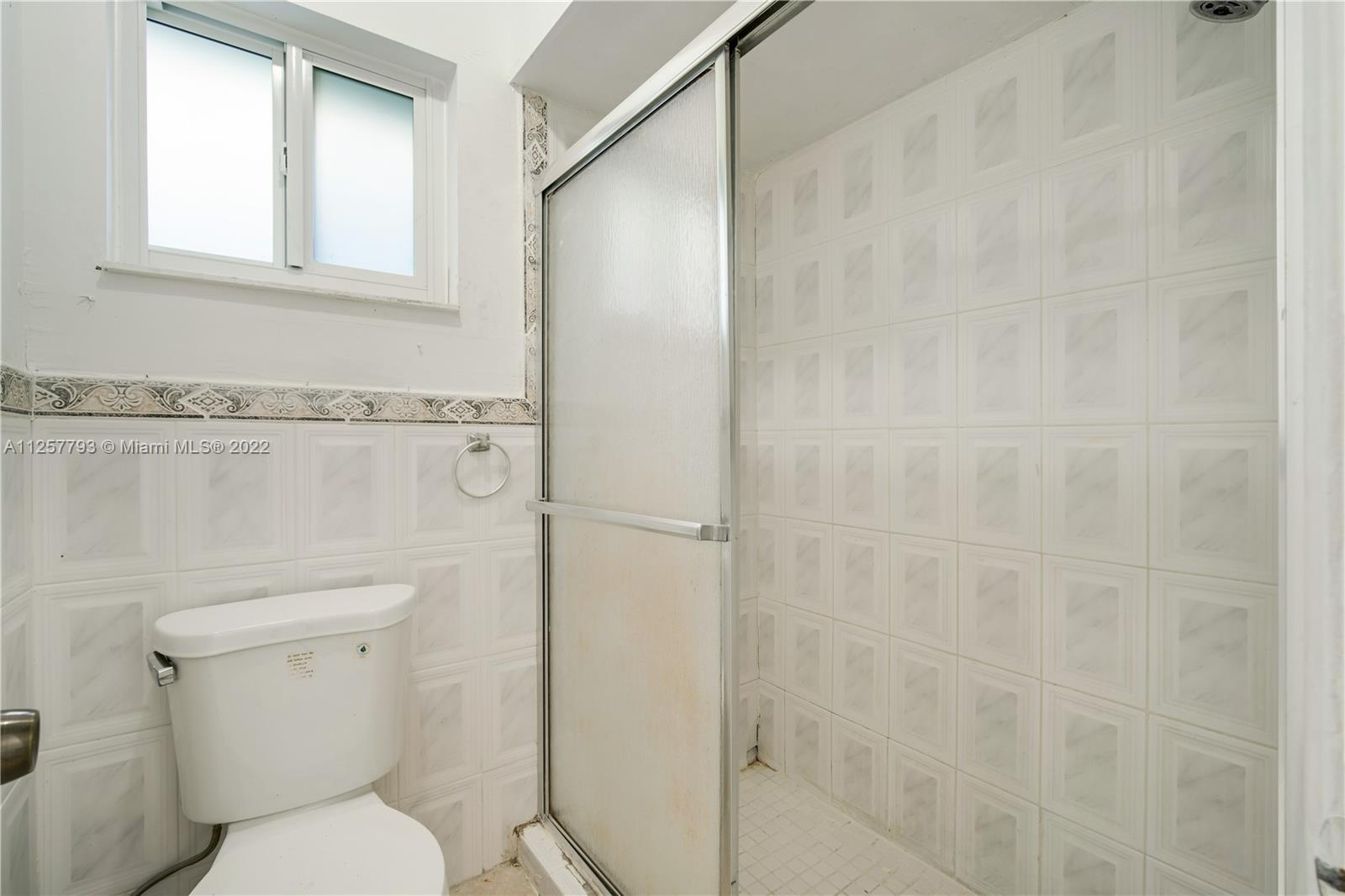 14121 Southwest 47th Street Miami, FL 33175 - Photo 13 of 45 a bathroom with a toilet and a shower