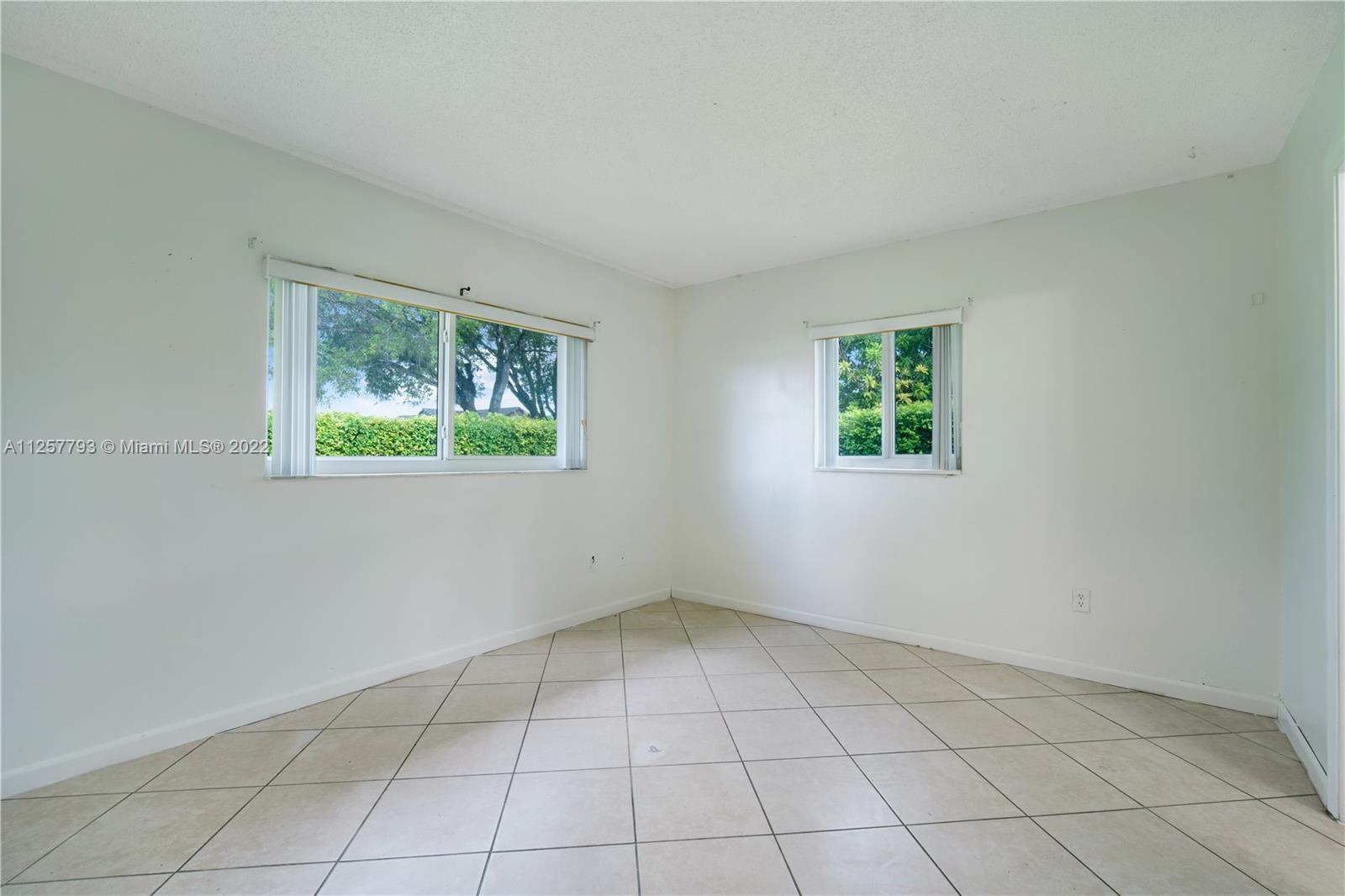 14121 Southwest 47th Street Miami, FL 33175 - Photo 14 of 45 an empty room with a window