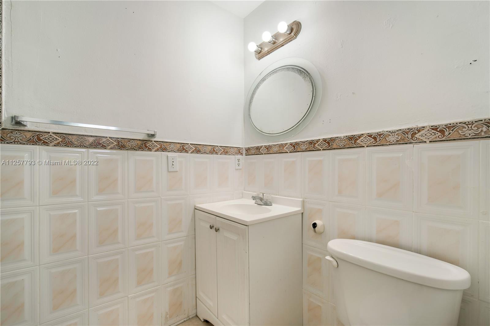 14121 Southwest 47th Street Miami, FL 33175 - Photo 16 of 45 a bathroom with a granite countertop bathtub a sink a toilet and shower