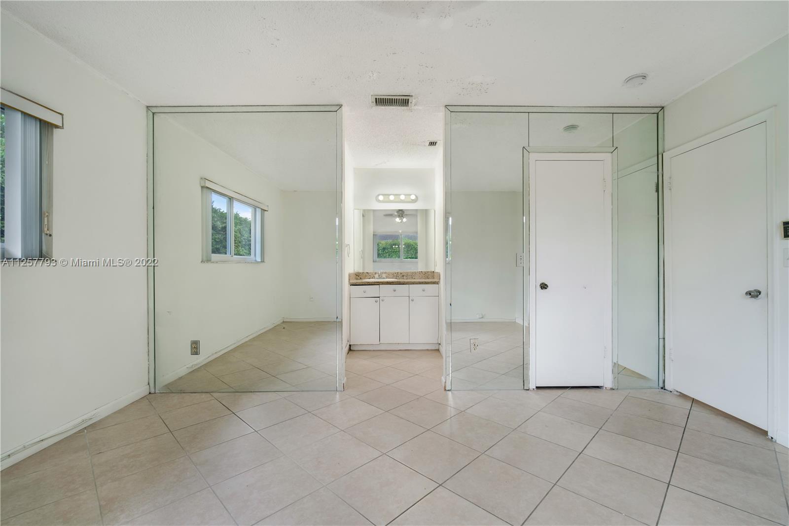 14121 Southwest 47th Street Miami, FL 33175 - Photo 22 of 45 a view of a big room with windows and closet