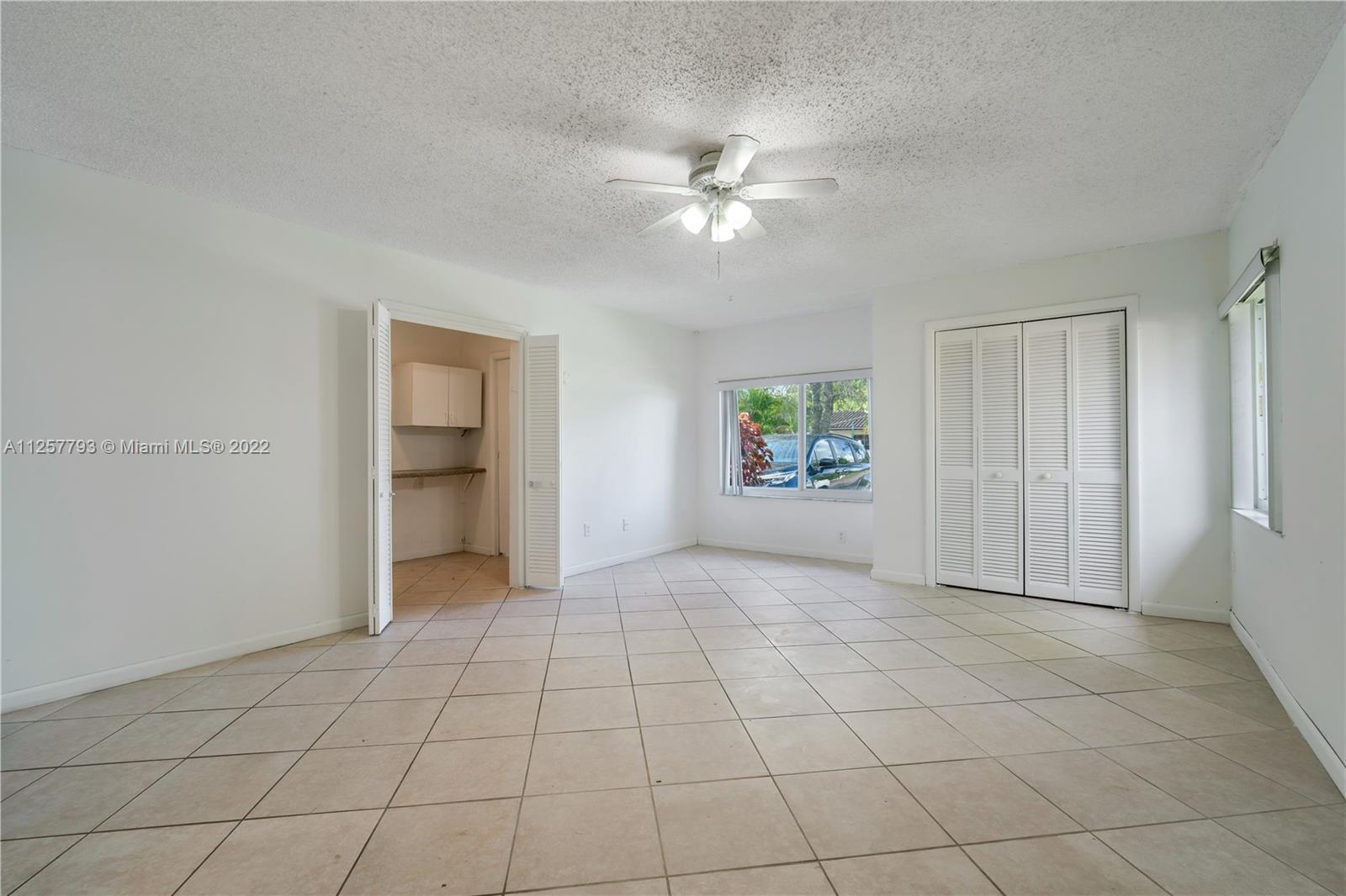 14121 Southwest 47th Street Miami, FL 33175 - Photo 26 of 45 an empty room with closet and windows