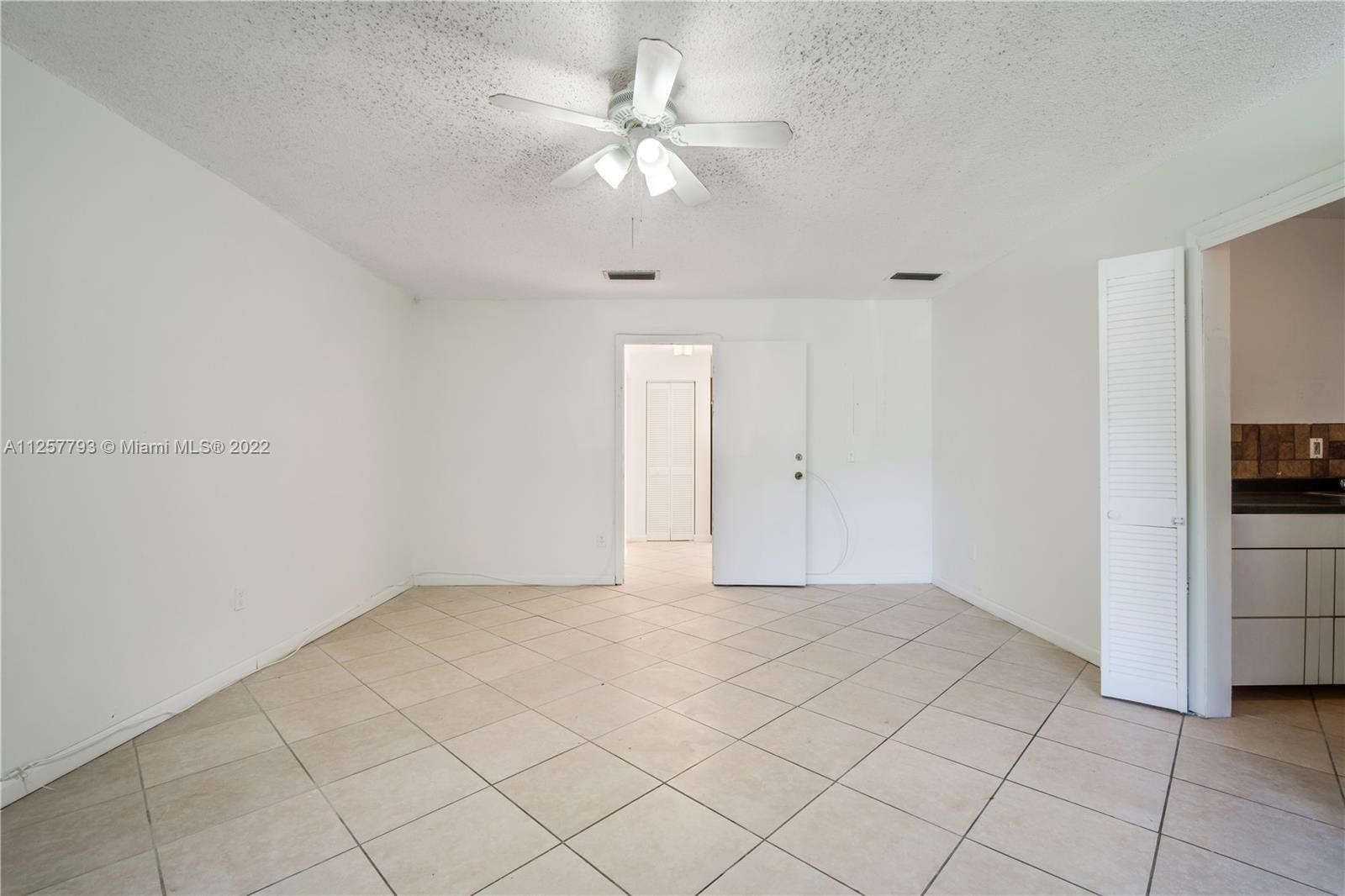 14121 Southwest 47th Street Miami, FL 33175 - Photo 27 of 45 a view of an empty room with a fan