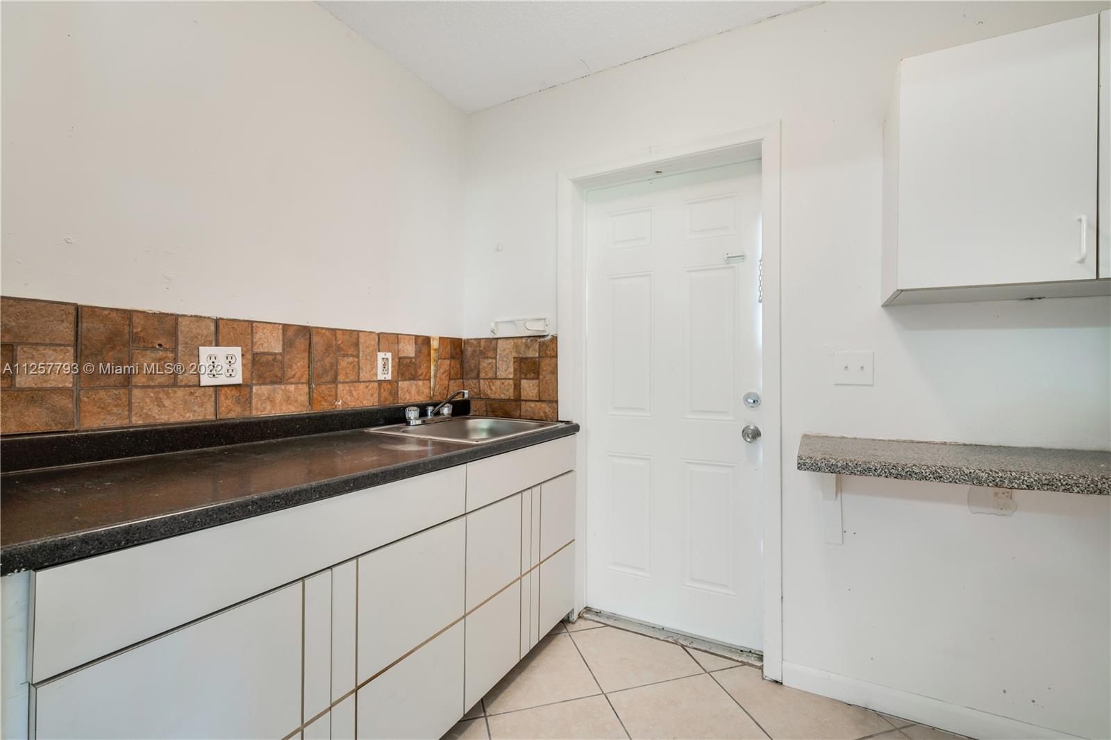 14121 Southwest 47th Street Miami, FL 33175 - Photo 29 of 45 a kitchen with stainless steel appliances granite countertop a sink and a stove