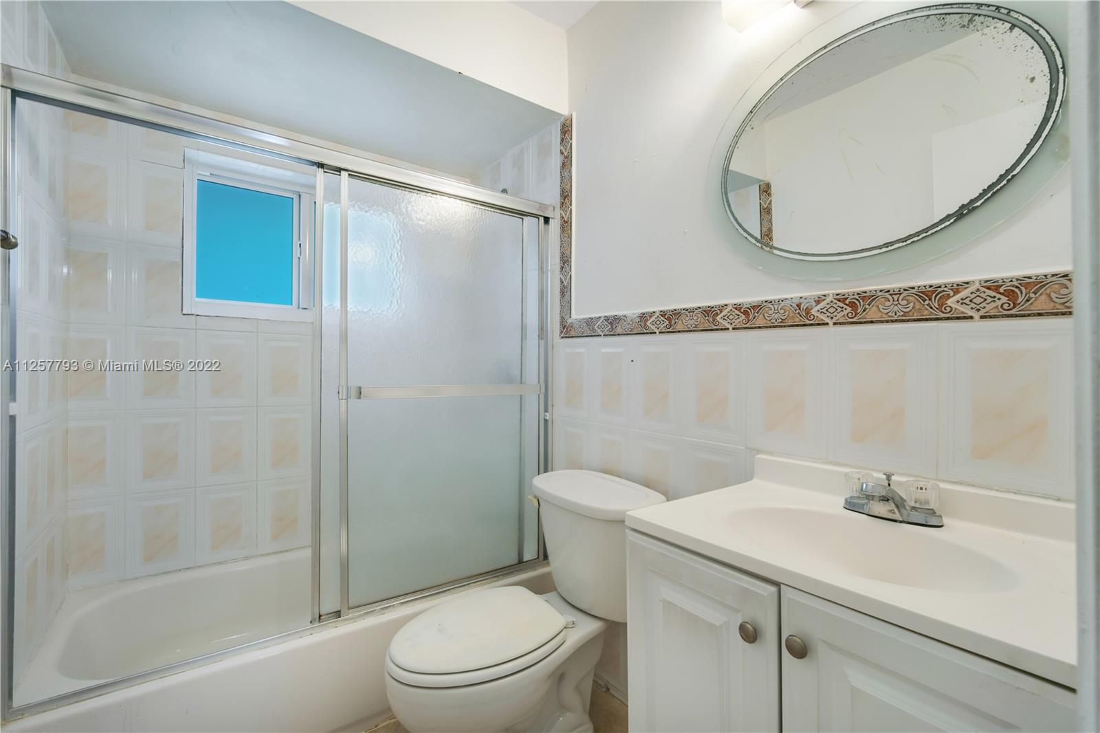 14121 Southwest 47th Street Miami, FL 33175 - Photo 33 of 45 a bathroom with a sink a mirror a toilet and shower