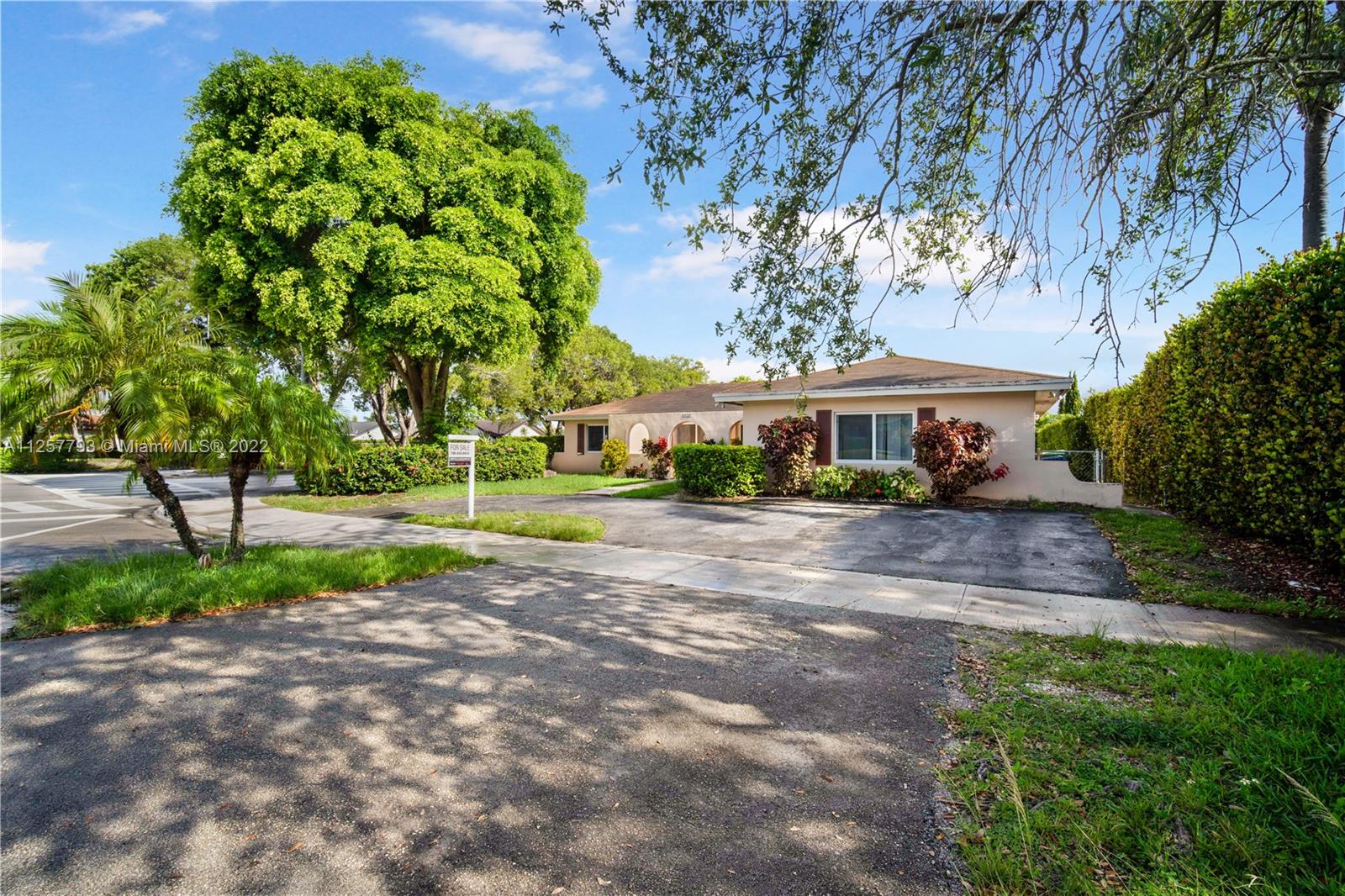 14121 Southwest 47th Street Miami, FL 33175 - Photo 4 of 45 a front view of a house with a yard