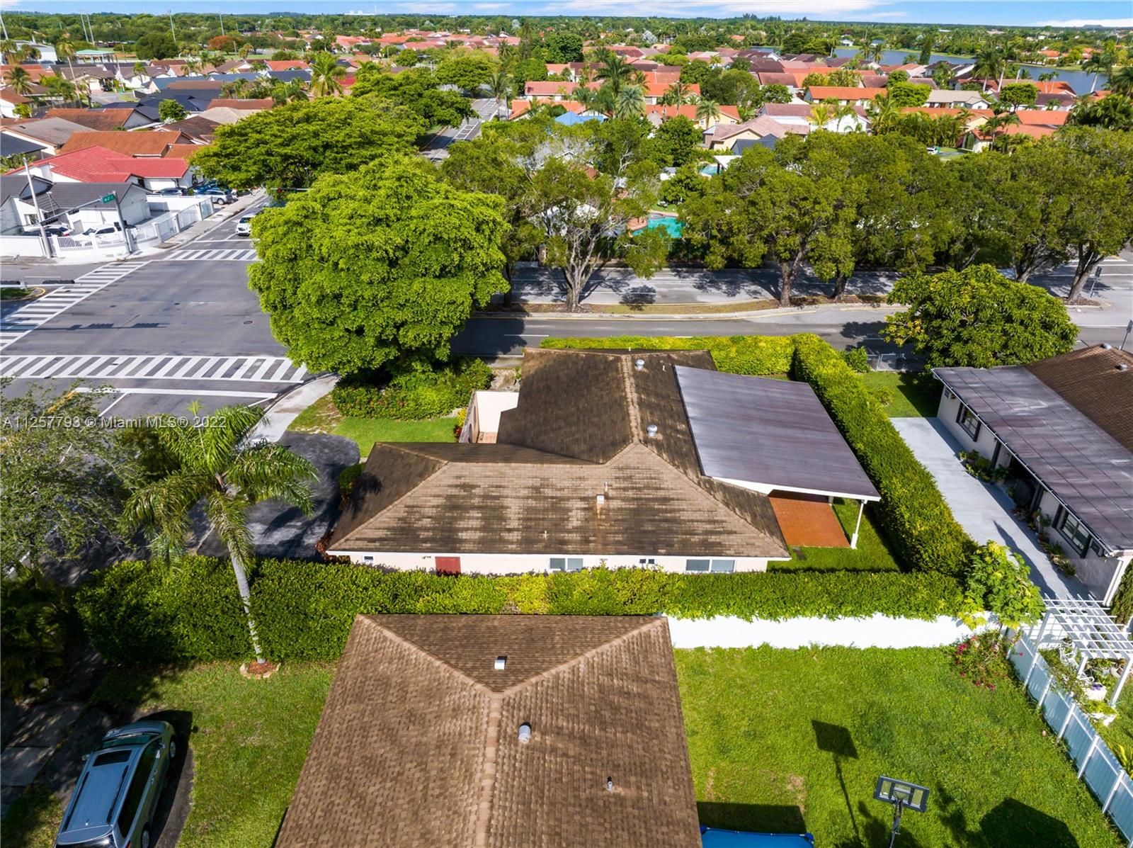 14121 Southwest 47th Street Miami, FL 33175 - Photo 41 of 45 a view of swimming pool with lawn chairs and plants